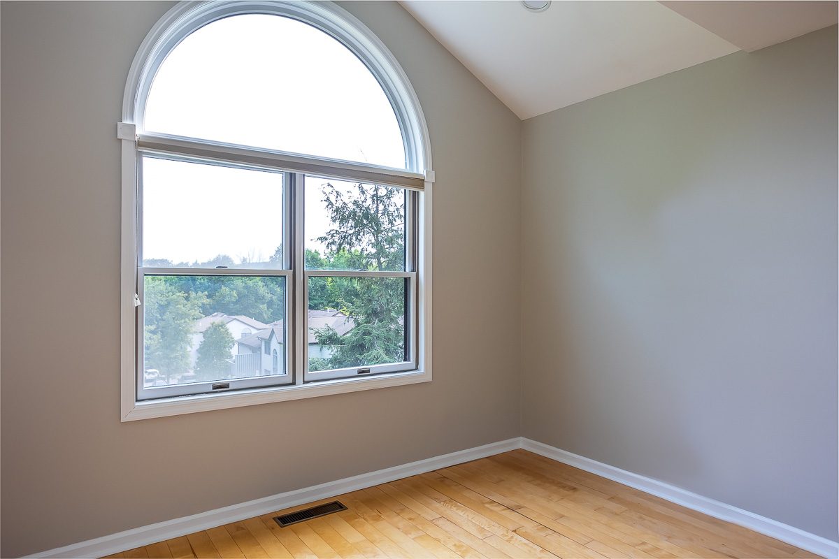Bedroom with arched window detail after painting