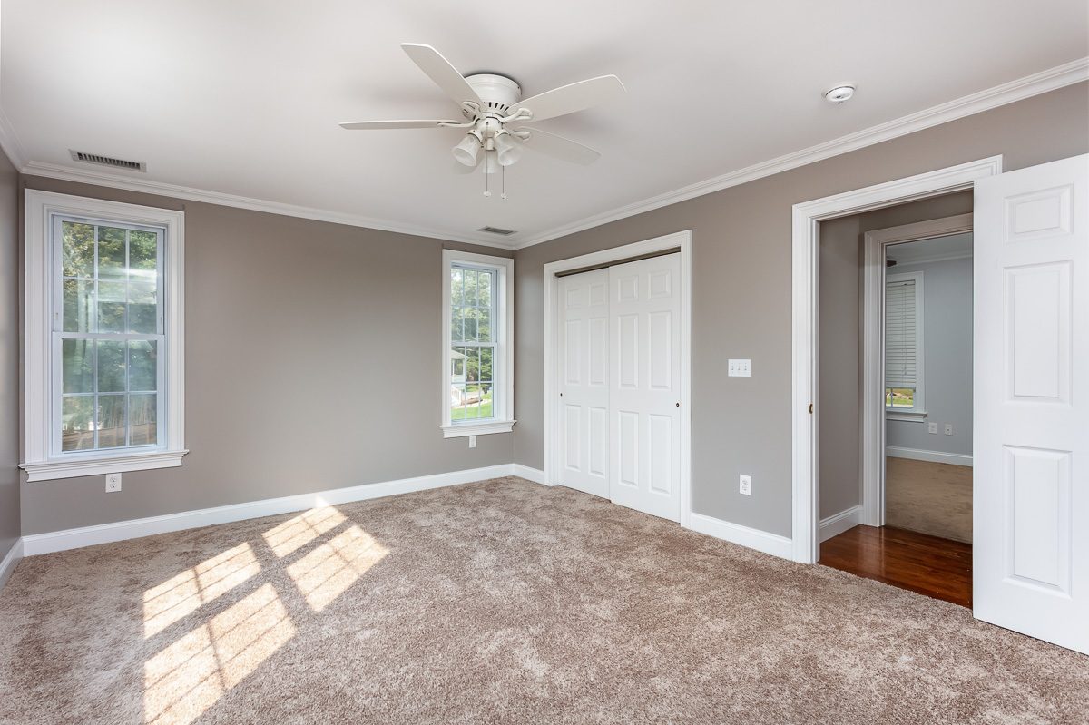Primary bedroom repainted in a warm neutral